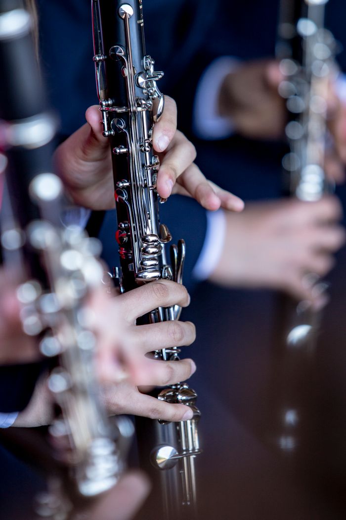 Close-up of musicians playing clarinets during a performance in Barcelos, Portugal.