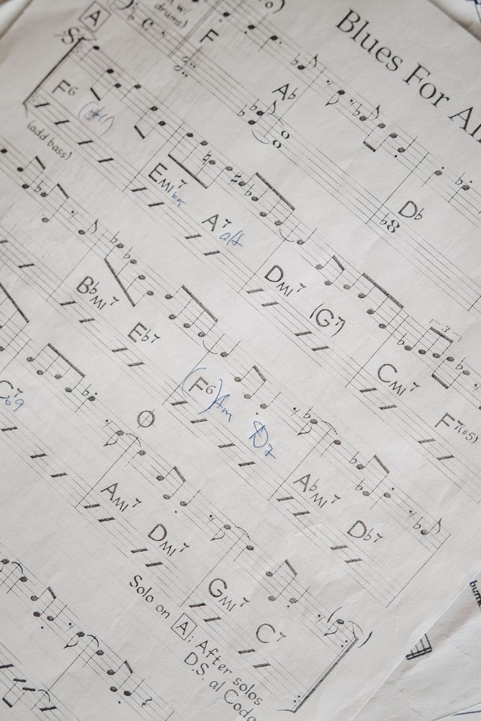 Close-up shot of musical notation in a blues sheet music, highlighting chords and key signatures.